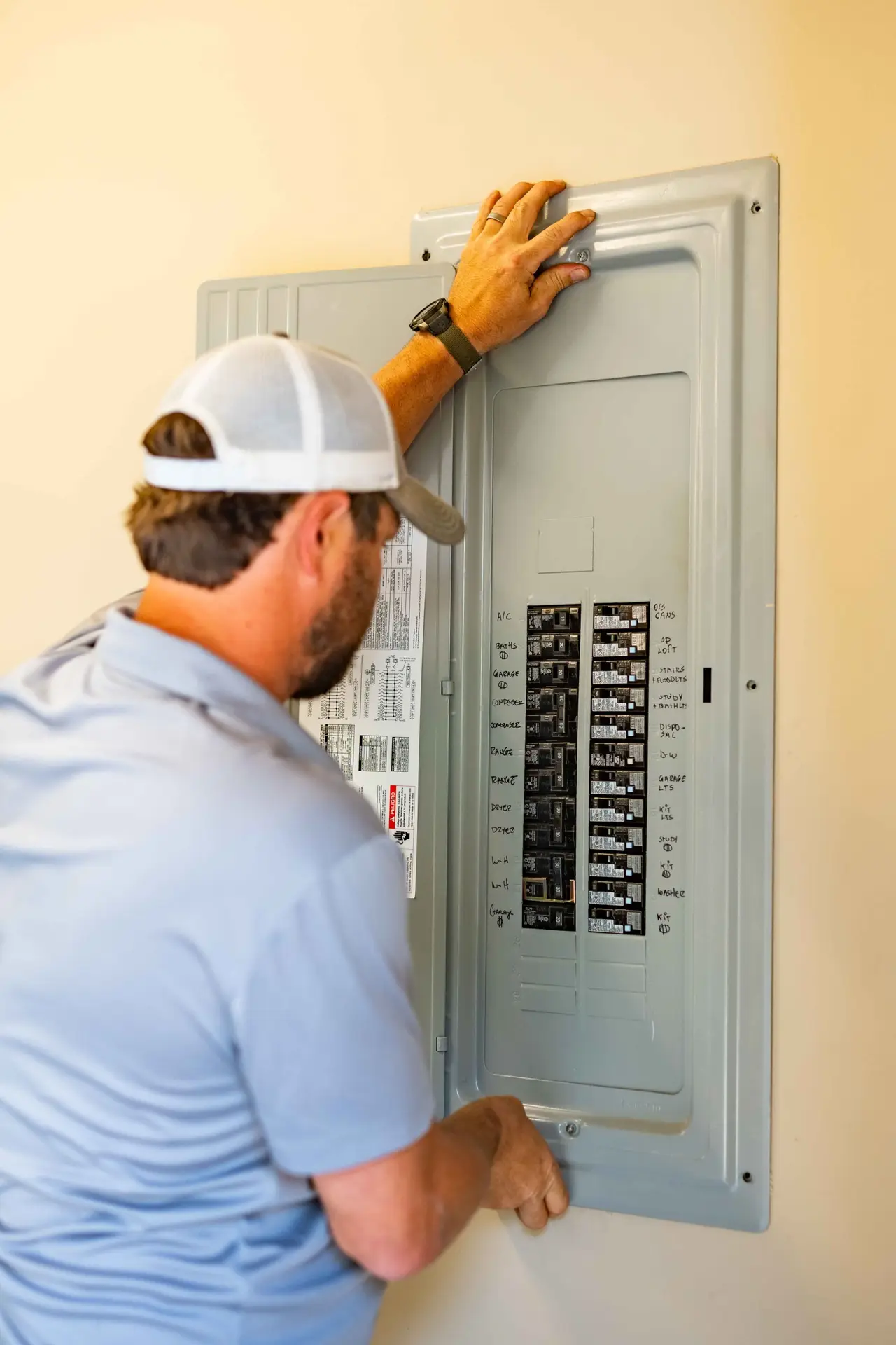 Airstream electrician working inside a residential electrical panel