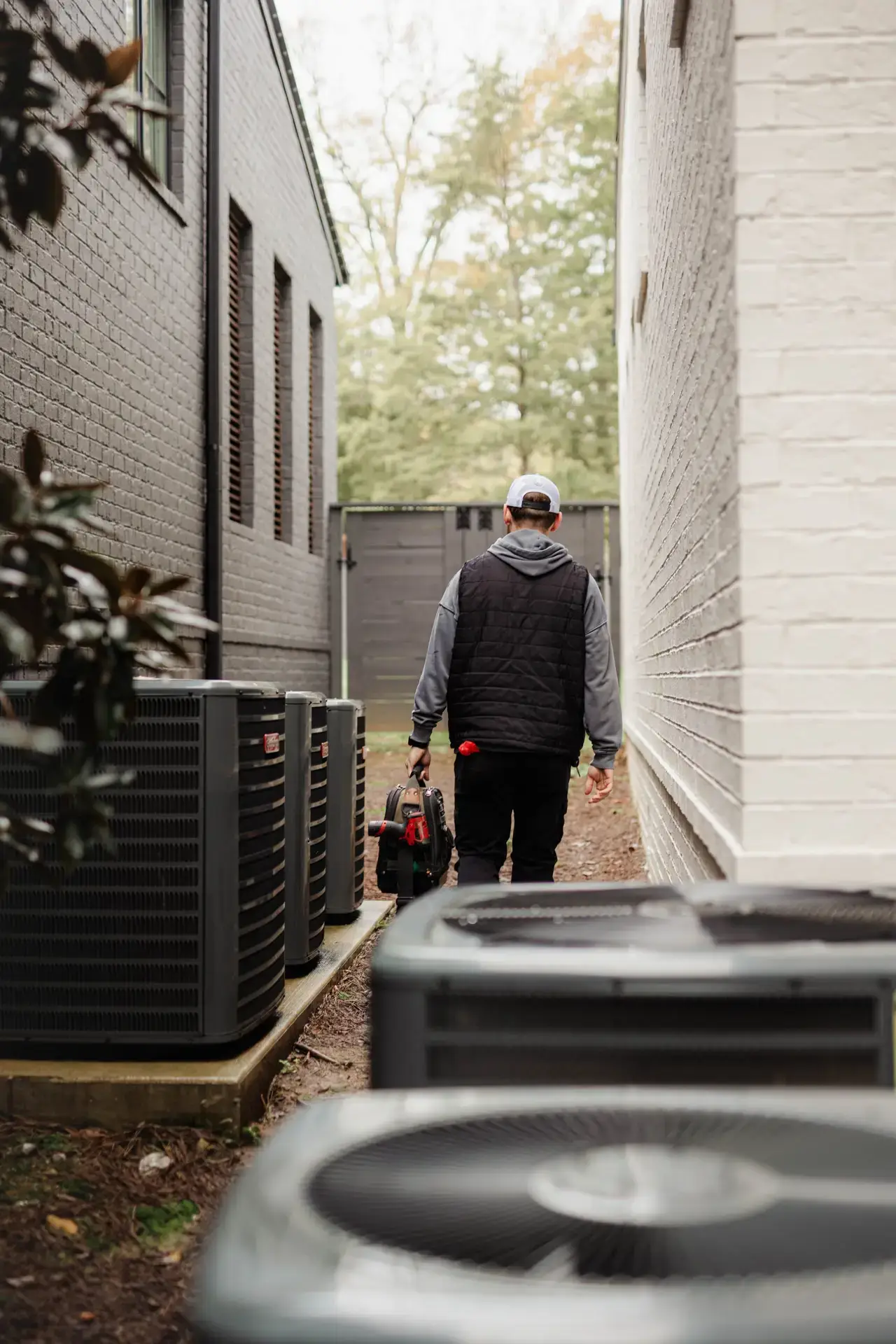 Technician servicing an outdoor air conditioning unit