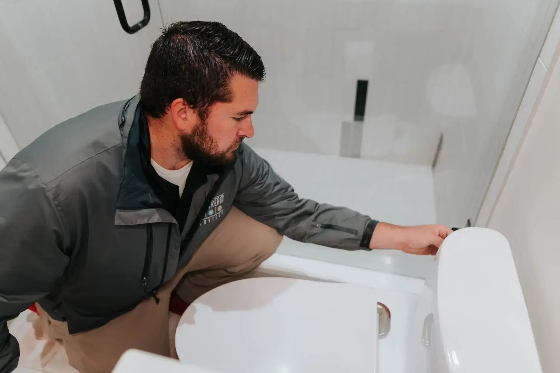 Plumber working under a kitchen sink