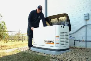 Technician at Airstream Services standing with installed Genera backup generator